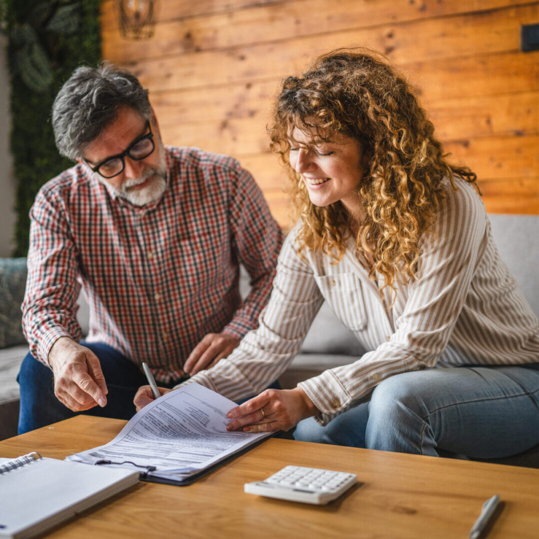 Couple reviewing documents at home together.